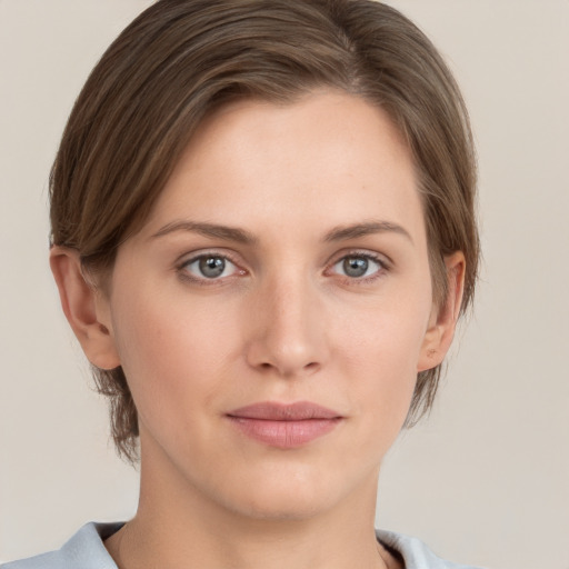 Joyful white young-adult female with short  brown hair and grey eyes