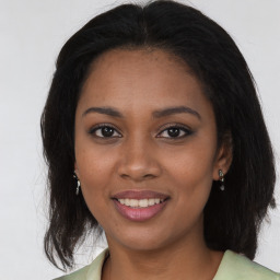 Joyful black young-adult female with medium  brown hair and brown eyes