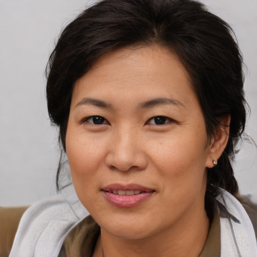 Joyful asian adult female with medium  brown hair and brown eyes