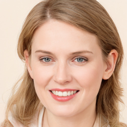 Joyful white young-adult female with medium  brown hair and blue eyes