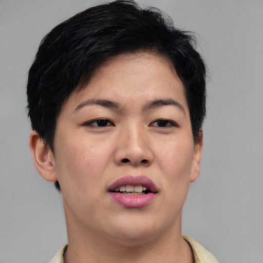 Joyful asian young-adult female with short  brown hair and brown eyes