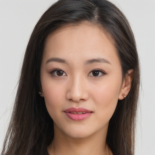 Joyful asian young-adult female with long  brown hair and brown eyes