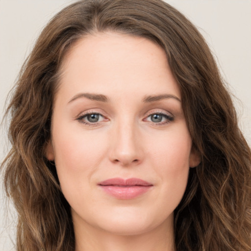 Joyful white young-adult female with long  brown hair and green eyes