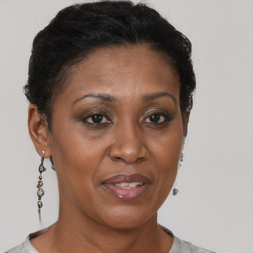 Joyful black adult female with short  brown hair and brown eyes