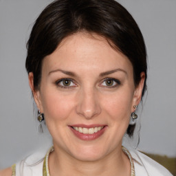 Joyful white adult female with medium  brown hair and grey eyes