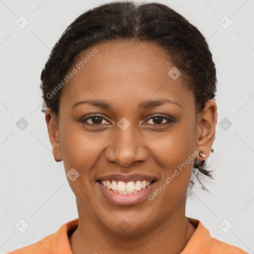 Joyful black young-adult female with short  brown hair and brown eyes