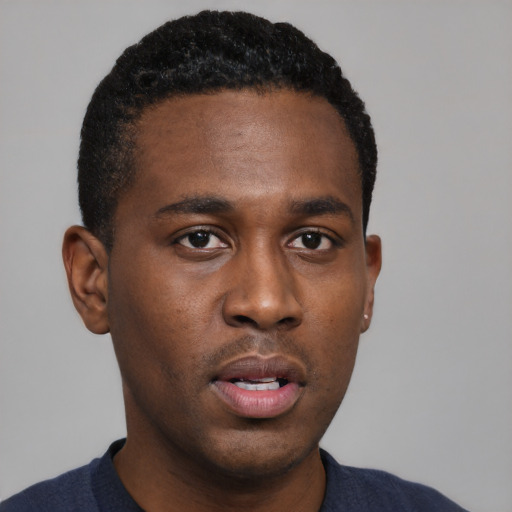 Neutral black young-adult male with short  black hair and brown eyes