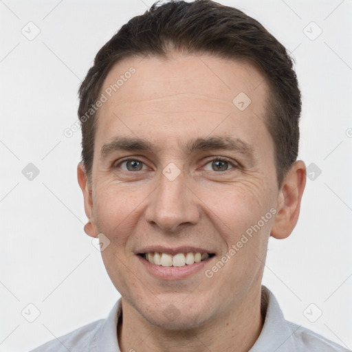 Joyful white adult male with short  brown hair and brown eyes