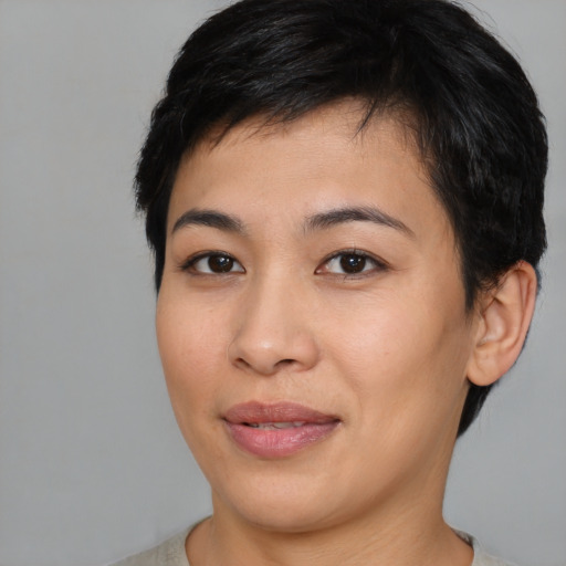 Joyful asian young-adult female with short  brown hair and brown eyes
