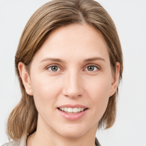 Joyful white young-adult female with medium  brown hair and blue eyes