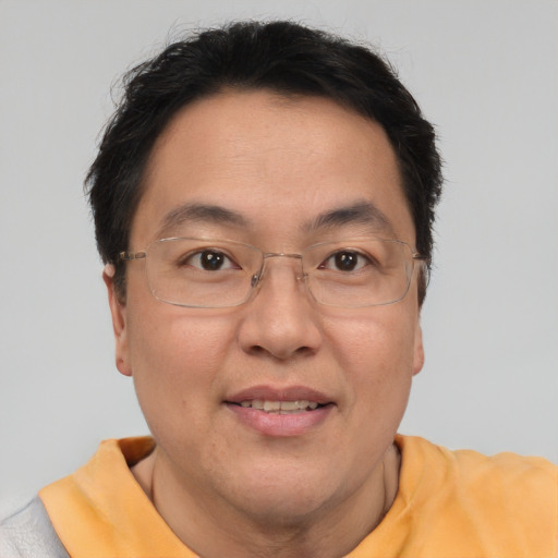 Joyful asian adult male with short  brown hair and brown eyes