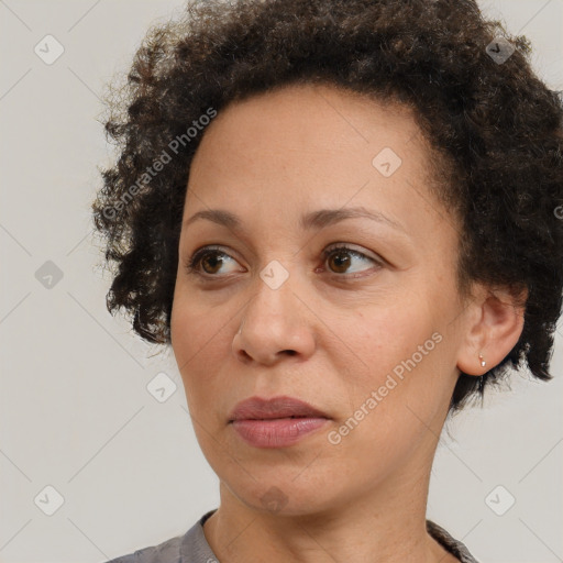 Joyful black adult female with short  brown hair and brown eyes