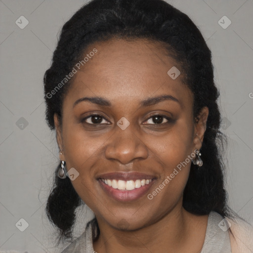 Joyful black young-adult female with long  black hair and brown eyes