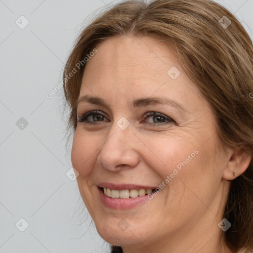 Joyful white adult female with long  brown hair and brown eyes