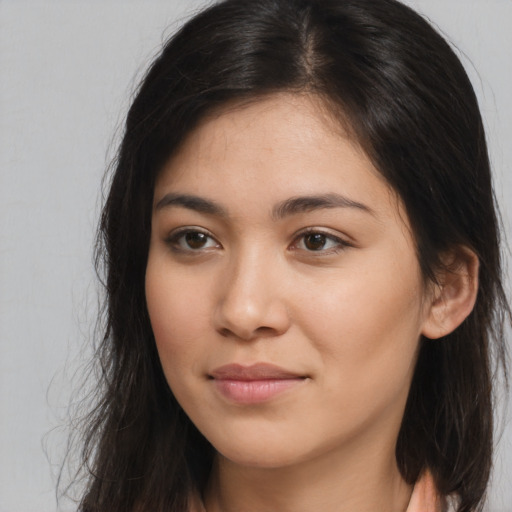 Joyful asian young-adult female with long  brown hair and brown eyes