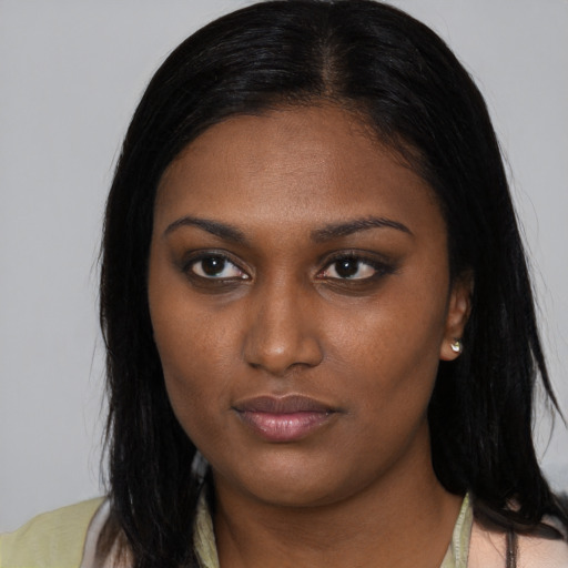 Neutral black young-adult female with medium  brown hair and brown eyes