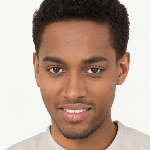 Joyful black young-adult male with short  brown hair and brown eyes