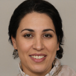 Joyful white adult female with medium  brown hair and brown eyes