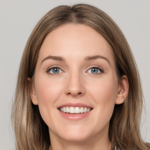 Joyful white young-adult female with long  brown hair and grey eyes