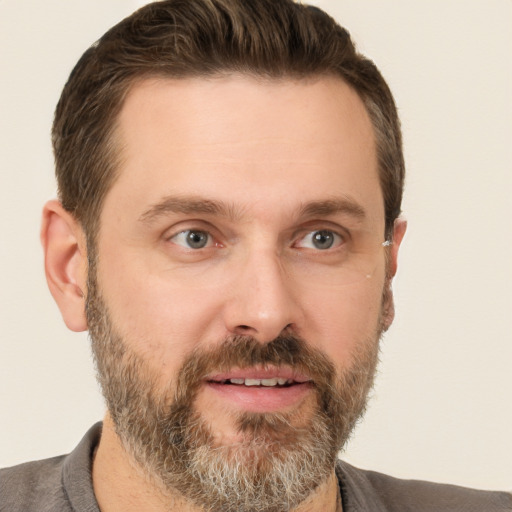 Joyful white adult male with short  brown hair and brown eyes