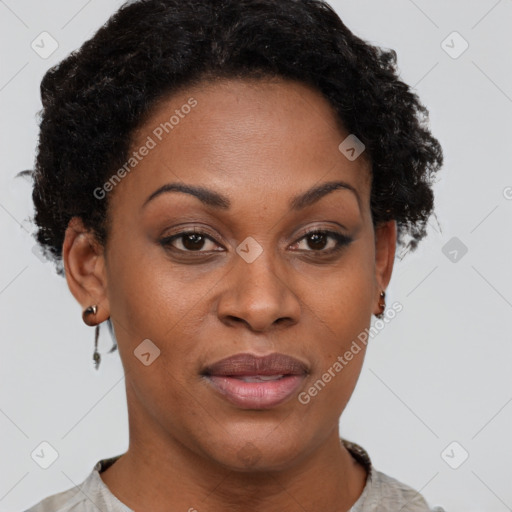 Joyful black adult female with short  brown hair and brown eyes