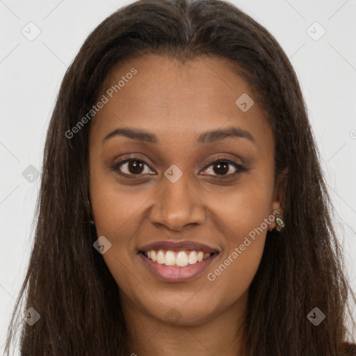 Joyful black young-adult female with long  brown hair and brown eyes