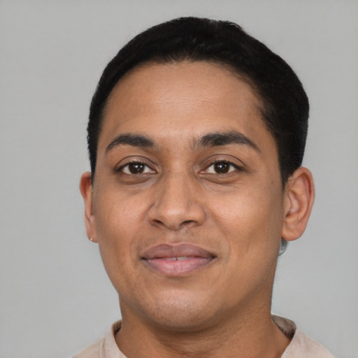 Joyful latino adult male with short  black hair and brown eyes