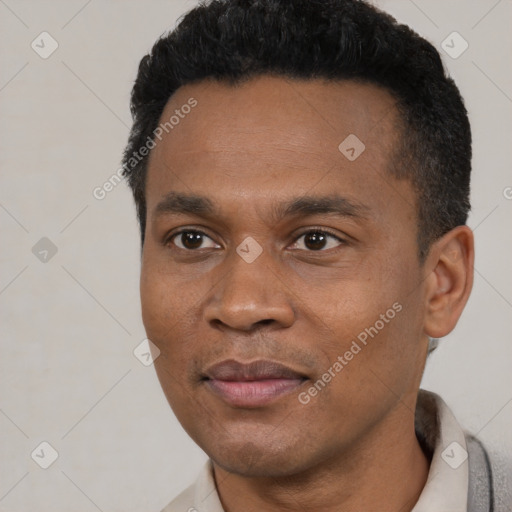 Joyful black young-adult male with short  black hair and brown eyes