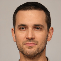 Joyful white young-adult male with short  brown hair and brown eyes