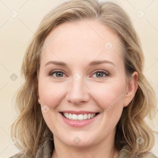 Joyful white young-adult female with long  brown hair and blue eyes