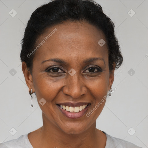 Joyful black adult female with short  brown hair and brown eyes