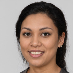 Joyful latino young-adult female with medium  brown hair and brown eyes