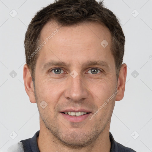 Joyful white adult male with short  brown hair and brown eyes