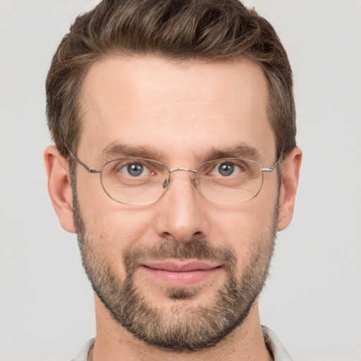 Joyful white adult male with short  brown hair and brown eyes