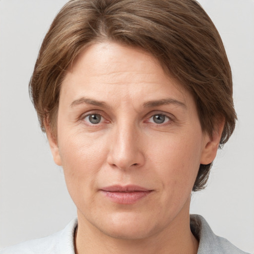 Joyful white adult female with short  brown hair and grey eyes