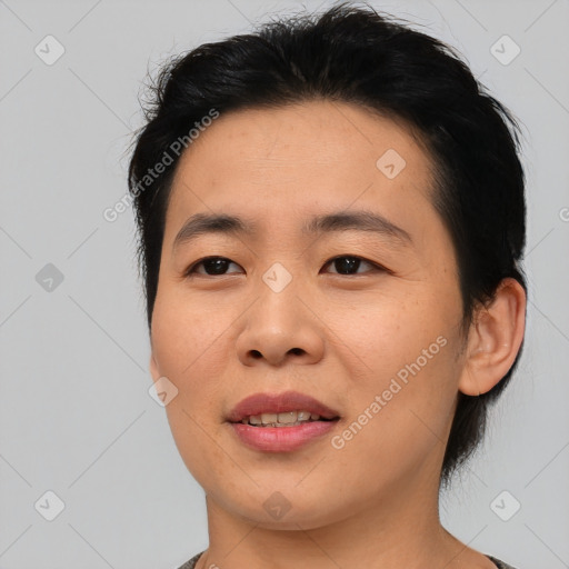 Joyful asian young-adult male with short  black hair and brown eyes