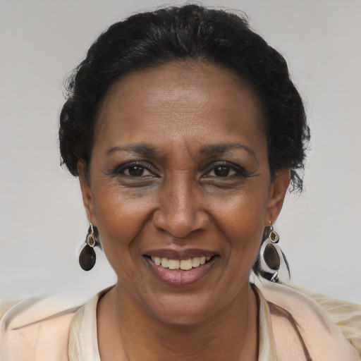 Joyful black adult female with medium  brown hair and brown eyes