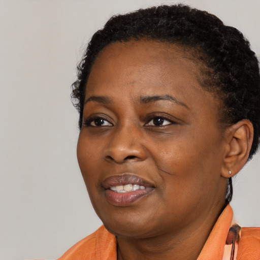 Joyful black adult female with short  black hair and brown eyes
