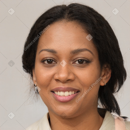 Joyful black adult female with medium  brown hair and brown eyes