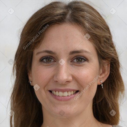 Joyful white adult female with long  brown hair and grey eyes