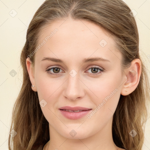 Joyful white young-adult female with long  brown hair and green eyes