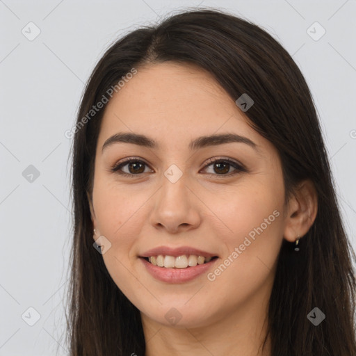 Joyful white young-adult female with long  brown hair and brown eyes