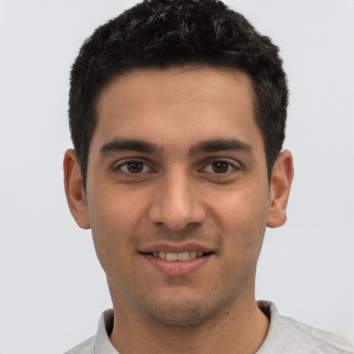 Joyful white young-adult male with short  black hair and brown eyes