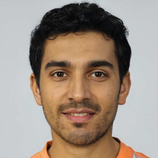 Joyful latino young-adult male with short  black hair and brown eyes