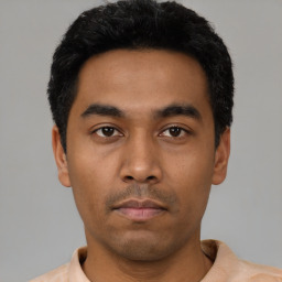 Neutral latino young-adult male with short  black hair and brown eyes
