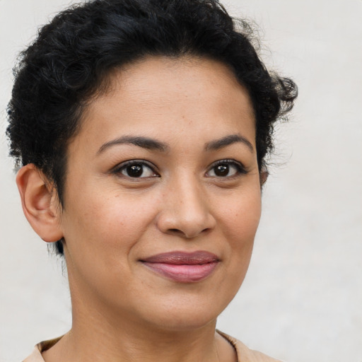 Joyful latino young-adult female with short  brown hair and brown eyes