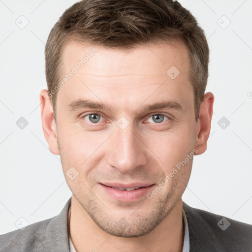 Joyful white young-adult male with short  brown hair and grey eyes