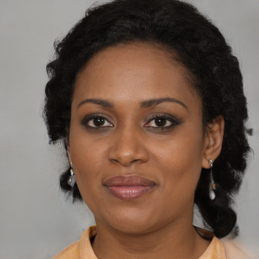 Joyful black young-adult female with medium  brown hair and brown eyes
