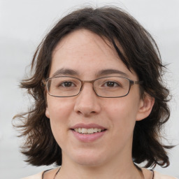 Joyful white adult female with medium  brown hair and brown eyes