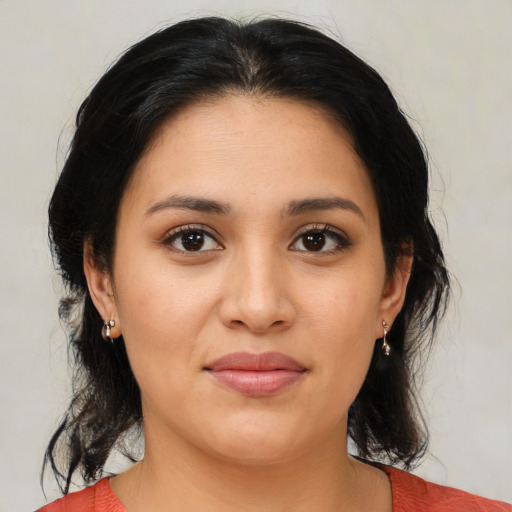 Joyful latino young-adult female with medium  brown hair and brown eyes